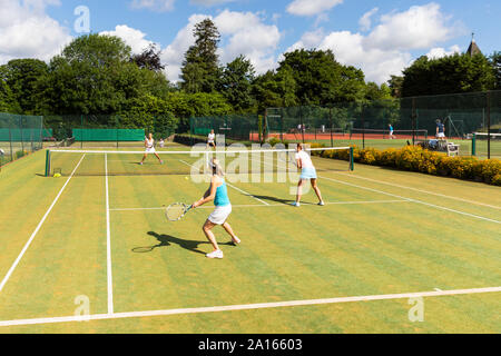 Mature women during a tennis match on grass court Stock Photo