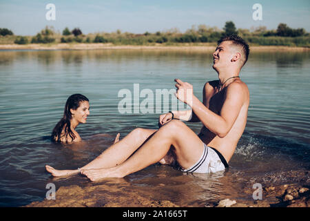 Young couple having fun in a lake Stock Photo