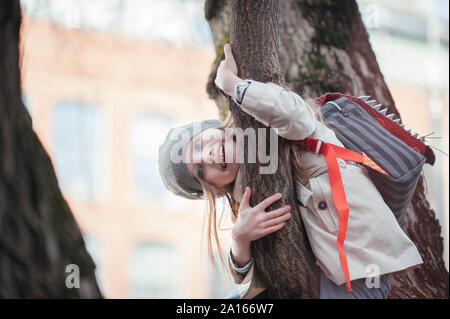 Portrait of happy girl in a tree Stock Photo