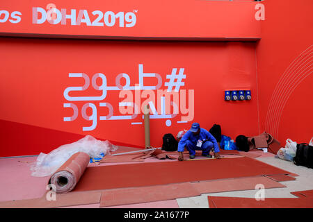 A worker prepares the Khalifa International Stadium ahead of the 2019 IAAF World Athletics Championships which takes place in Doha, Qatar, between the 27th September and 6th October, 2019. Stock Photo