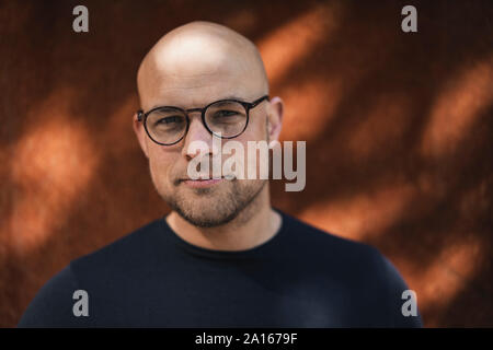 Portrait of bald man with beard wearing glasses Stock Photo