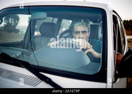 Mature man sitting in his off-road vehicle Stock Photo