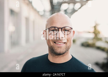 Portrait of smiling bald man wearing glasses Stock Photo