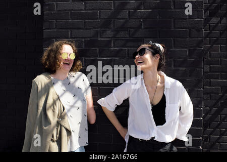 Happy woman with below-elbow amputation talking with her friend Stock Photo
