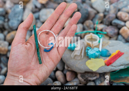 Woman's hand with plastic waste Stock Photo
