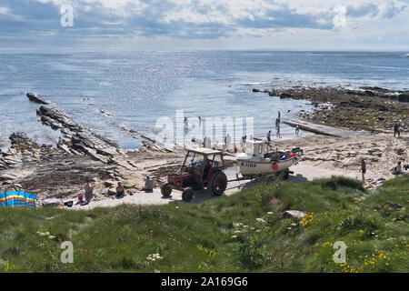 dh Birsay bay BIRSAY ORKNEY Tractor and fishing boat trailer people on beach summer sunshine beaches sun