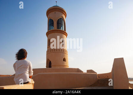 Rear view of man looking to Sur Lighthouse, Oman Stock Photo