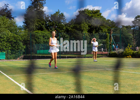 Mature women during a tennis match on grass court Stock Photo