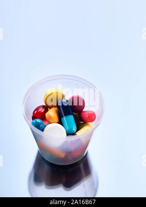 Medicine, Pills in a plastic cup Stock Photo