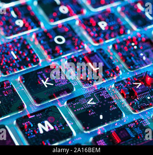 Double exposure of a laptop computer showing electronic components under the keyboard Stock Photo