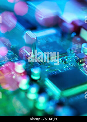 Fibre optics carrying data passing across electronic circuit board Stock Photo