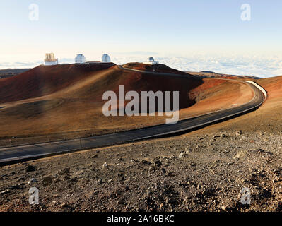 Empty road leading to W. M. Keck Observatory against blue sky during sunset Stock Photo