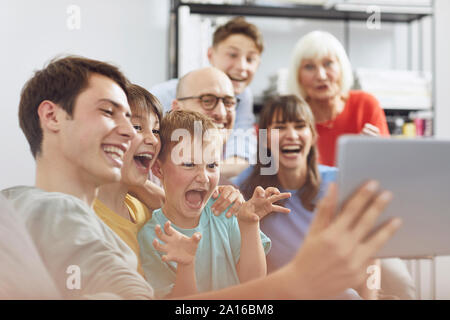 Big familiy having fun at home, using digital tablet Stock Photo