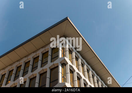Roof eaves over darkened glass in windows of Lucerne building, Switzerland Stock Photo