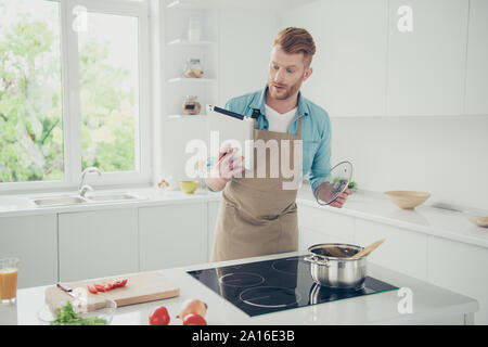 Good-looking man try figure new menu hold tablet gadget in hand Stock Photo