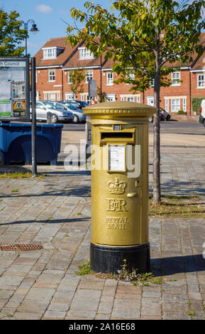 Olympic Gold pillar box for cyclist Dani King in The Square in Hamble-le-Rice, a coastal village on the Solent, Hampshire, south coast England, UK Stock Photo