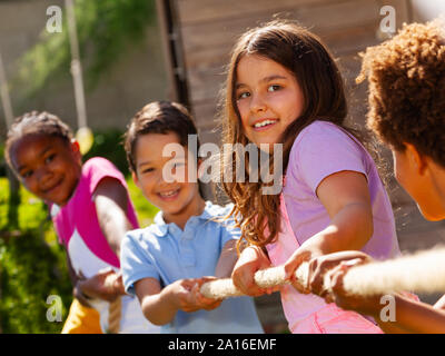 Rope pulling game portrait of kids in summer camp Stock Photo - Alamy