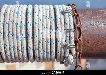 close up image of rope and chains of water well Stock Photo