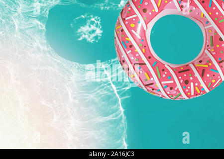 Inflatable ring of donut shape floating in the swimming pool, Stock Photo