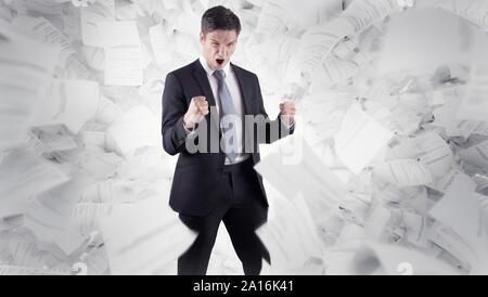 businessman in front of white background and flying documents Stock Photo