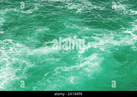 Sea waves close-up toned in pastel green or neo mint color Stock Photo