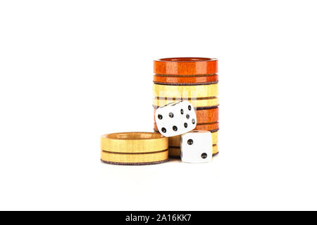 Dice and wooden backgammon checkers isolated on a white background. Copy space. Stock Photo
