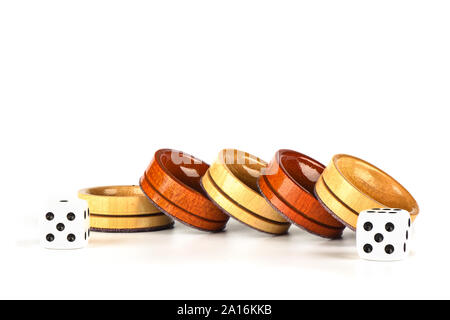 Dice and wooden backgammon checkers isolated on a white background. Copy space. Stock Photo