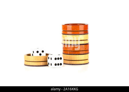 Dice and wooden backgammon checkers isolated on a white background. Copy space. Stock Photo