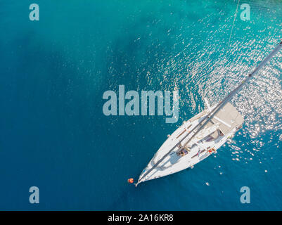 Sailing yacht, a delightful seascape drone photo. Clear blue sea. Sailing regatta, boat trip, top view. Stock Photo