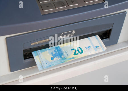 Euro banknotes dispensed from an ATM machine (bancomat) Stock Photo