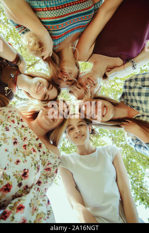 Different and happy in their bodies. Young women smiling, talking, walking and having fun together outdoors on sunny summer's day at park. Girl power, feminism, women's rights, friendship concept. Stock Photo