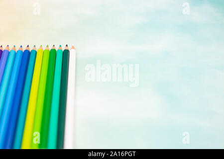 Colored pencils in different colors ordered on the table Stock Photo