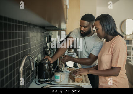 Young African American couple preparing breakfast in their kitchen Stock Photo