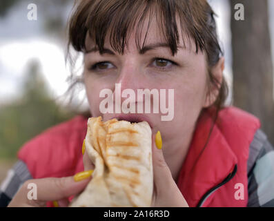 Young woman eating fast food, not healthy food. Unhealthy food Stock Photo