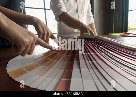 Graphic designers choose colors from the color bands samples for design .Designer graphic creativity working concept. Stock Photo