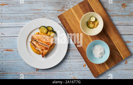 Mashed sweet potato with coconut milk and grilled salmon on bright mediterranean background. Image represents healthy paleo eating, autoimmune disease Stock Photo