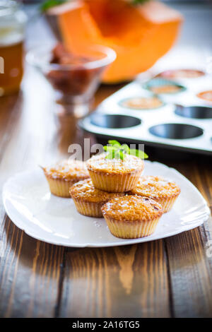 baked sweet pumpkin muffins with dried apricots inside, Stock Photo