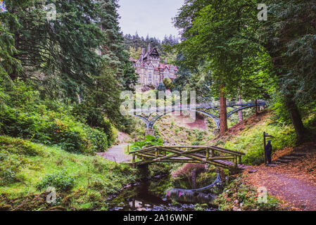 Rock garden and stream leading to Cragside House, Northumberland, UK Stock Photo