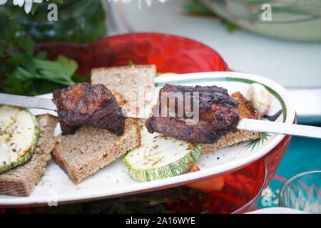 Served on plate shashlik and baked vegetables, picnic outside, selective focus Stock Photo