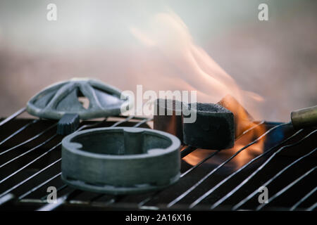 Close-up ignition of special coal burner for a hookah, selective focus Stock Photo
