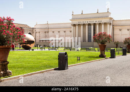 Courtyard of the Pinecone at Vatican, Rome, Italy. Sphere Within Sphere (Sfera con sfera) is a bronze sculpture by Italian sculptor Arnaldo Pomodoro, Stock Photo