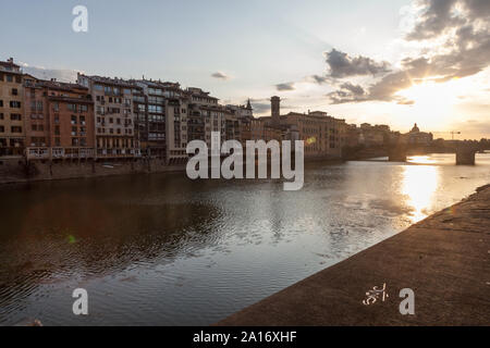 View of Arno River and Ponte Santa Trinita from Lungarno degli Acciaiuoli at Via Por Santa Maria. Florence, Italy Stock Photo