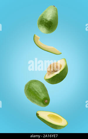 Avocado sliced isolated in blue background viewed from above Stock Photo