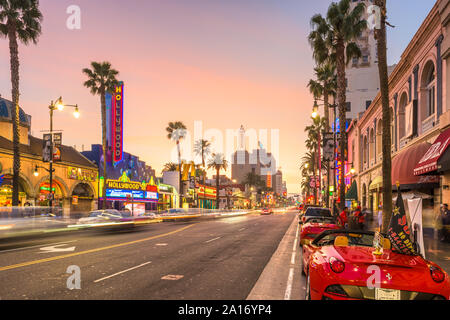 LOS ANGELES, CALIFORNIA - MARCH 1, 2016: Traffic on Hollywood Boulevard at dusk. The theater district is famous tourist attraction.