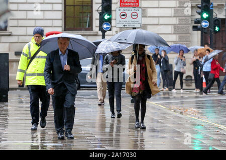 London, UK. 24th Sep, 2019. A man shelters under an umbrella during heavy downpour in London. According to the Met Office, remnants of Hurricane Humberto is forecast to batter the UK with heavy downpour for the next few days. Credit: Steve Taylor/SOPA Images/ZUMA Wire/Alamy Live News Stock Photo