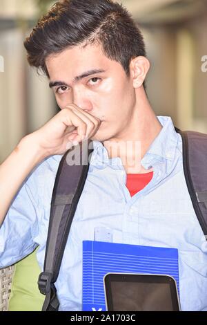 Worried Filipino Boy Student With Books Stock Photo