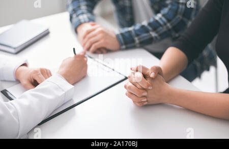 Doctor writing prescription and treatment plan to patients Stock Photo