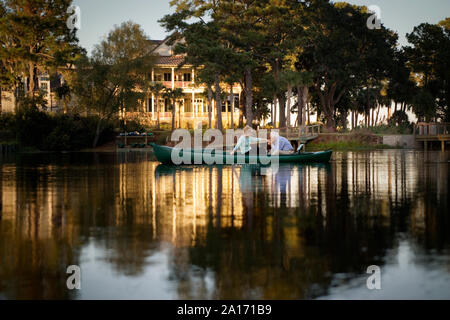 Happy senior couple holding hands while in a canoe. Stock Photo