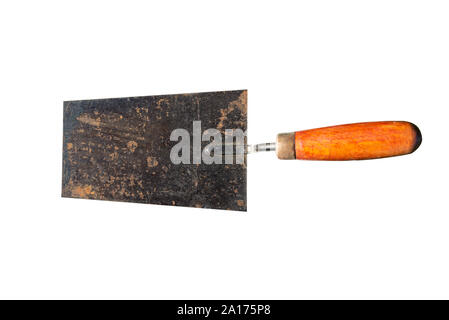 An old, rusty trowel with an orange handle on the right, isolated on white background with a clipping path. Stock Photo