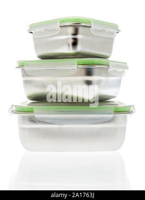 A collection of stainless steel containers used for food storage with locking covers that may be taken for lunch Stock Photo